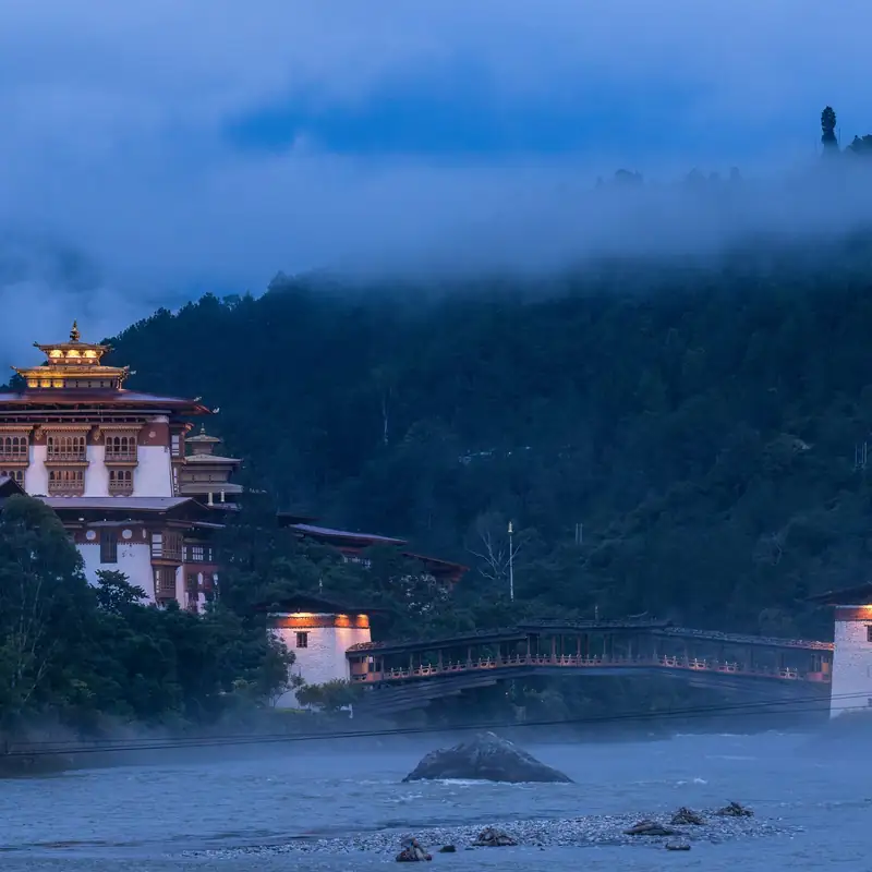 Punakha Dzong lit up at dusk above the river