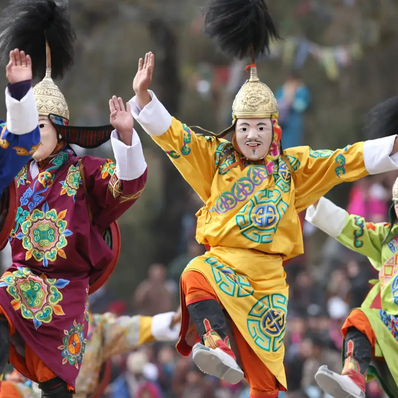 Masked dancers performing at a tsechu festival